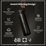 A black, double-walled stainless steel water bottle is being held; it features a hide-away handle, wide mouth, and hygiene cover. The bottle is shown against a dark background, and boasts several design awards.