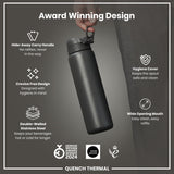 A dark-grey, double-walled stainless steel water bottle is held by a hand; it features a hide-away handle, crevice-free design, hygiene cover, and wide mouth. The bottle is an award-winning design.