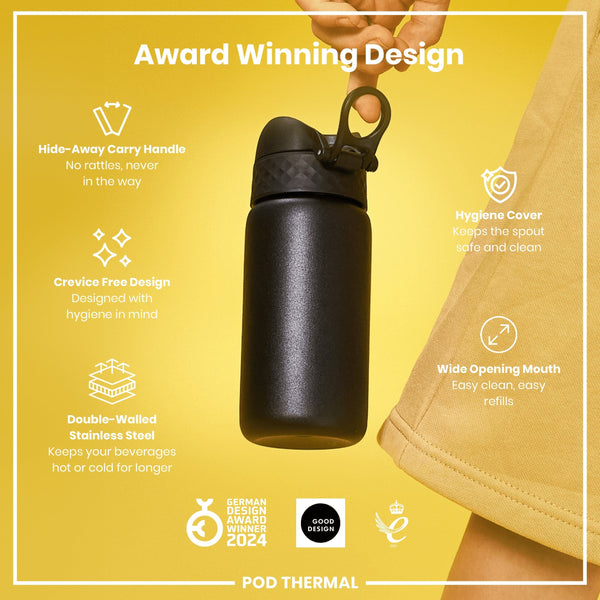 A black, double-walled stainless steel water bottle is being held against a yellow background. The bottle features a hide-away carry handle, crevice-free design, hygiene cover, and a wide opening mouth. It's a 2024 German Design Award winner.