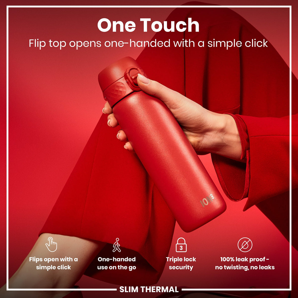 A red, slim thermal water bottle is being held; its flip top opens one-handed with a simple click; against a red background.