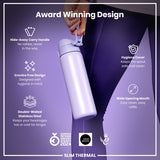 A lavender-colored, double-walled stainless steel water bottle is held by a person; its features are highlighted. The bottle is award-winning, with a hide-away handle, crevice-free design, hygiene cover, and wide opening mouth.
