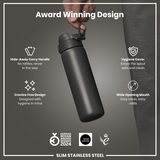 A dark gray, slim stainless steel water bottle is being held. Features include a hide-away handle, hygiene cover, and wide mouth. Awards from 2024 and 2021 are shown.