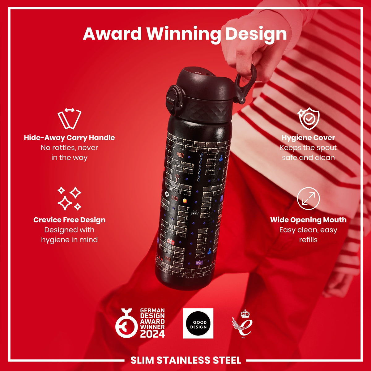 A black, slim stainless steel water bottle with a video game design is being held; it features a hide-away handle, hygiene cover, and wide mouth opening, against a red background. Award Winning Design. German Design Award Winner 2024. Good Design.