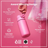 A pink, double-walled stainless steel water bottle is being held; it features a hide-away handle, crevice-free design, hygiene cover, and wide mouth. Award Winning Design. German Design Award Winner 2024. Good Design.