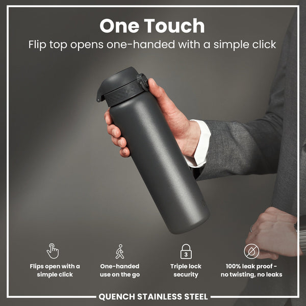 A dark gray stainless steel water bottle is held; its flip top opens with a single click. The bottle is shown against a gray background by a person wearing a suit. "One Touch," "Flips open with a simple click," "One-handed use on the go," "Triple lock security," "100% leak proof - no twisting, no leaks," and "QUENCH STAINLESS STEEL" are visible.