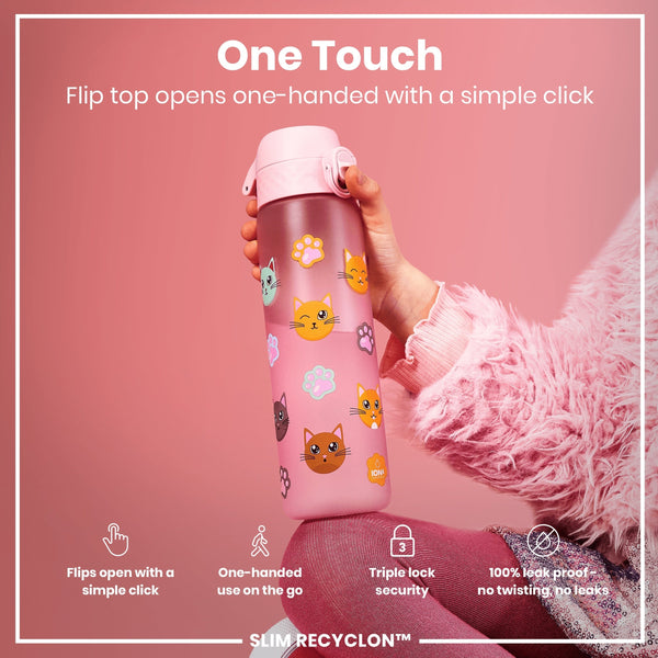 A pink water bottle, featuring cat and paw print designs, is being held; its flip top opens with a single click. The bottle is in the hand of someone wearing a fluffy pink sweater against a pink background. Flip top opens one-handed with a simple click. One-handed use on the go. Triple lock security. 100% leak proof - no twisting, no leaks. SLIM RECYCLON™.