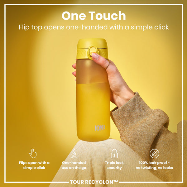 A yellow water bottle is being held; its flip top opens with a single click. It features one-handed operation, triple-lock security, and is 100% leakproof. The bottle is shown against a yellow background.