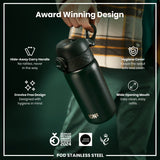 A dark-green, stainless steel water bottle is being held; its features, including a hide-away handle and wide mouth, are highlighted against a dark background. Award Winning Design. GERMAN DESIGN AWARD WINNER 2024. GOOD DESIGN. 2021. POD STAINLESS STEEL.