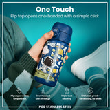 A child's hand holds a blue, space-themed water bottle. Its flip top opens easily with one hand. The scene is set against a teal background.