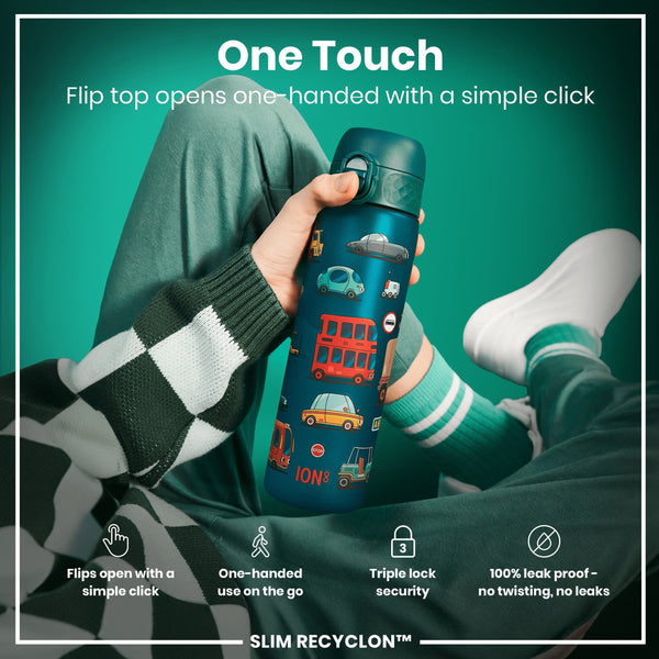A person holds a teal water bottle with a flip top and vehicle designs; the lid opens with one hand; the setting is a casual, promotional studio shot.