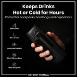 A black, cylindrical thermos is held; it keeps drinks hot or cold for hours, fitting in bags and cupholders. It is 360ml/12oz, 190 x 72mm, lunchbox friendly, has a silent silicone base, and is 100% leak proof.