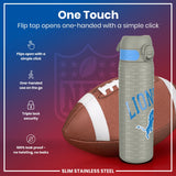 A gray water bottle, featuring a one-handed flip top, rests beside an American football. The bottle is slim, stainless steel, and leak-proof. The text on the bottle repeatedly says 