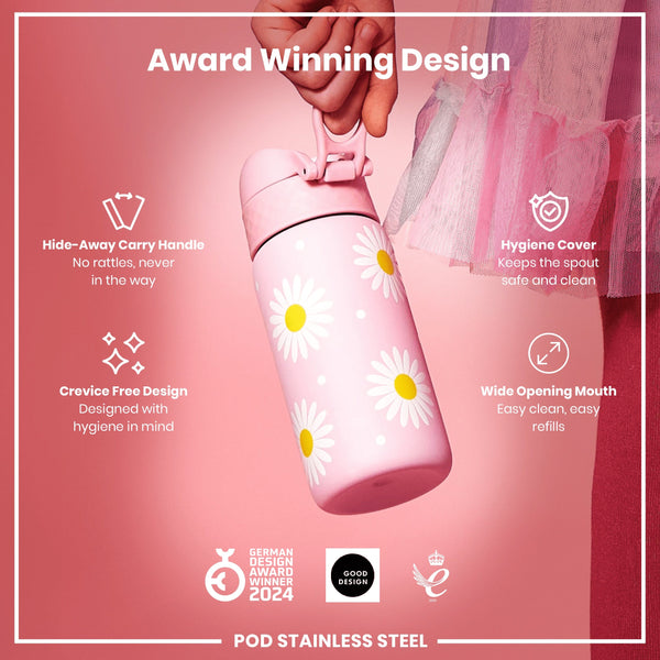 A pink, daisy-patterned stainless steel water bottle is being held; it features a hide-away handle, hygiene cover, and wide mouth. The bottle is an award-winning design.