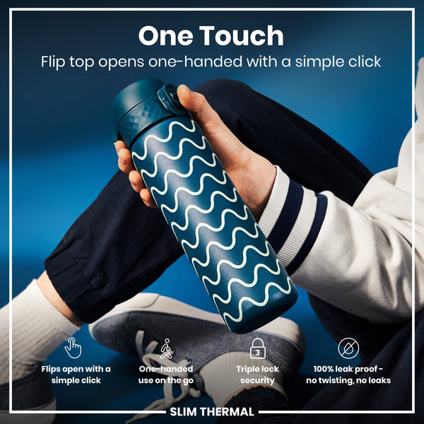 A teal water bottle with a wavy design is held; its flip top opens one-handed. The context is a person wearing casual clothes against a blue background. One Touch. Flip top opens one-handed with a simple click. Flips open with a simple click. One-handed use on the go. Triple lock security. 100% leak proof - no twisting, no leaks. SLIM THERMAL.