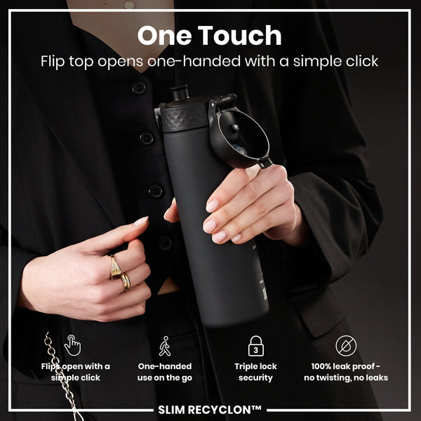 A black water bottle, being held, has a flip top that opens one-handed. The bottle features a triple lock security mechanism and is leak-proof. The context is a person wearing a black blazer.