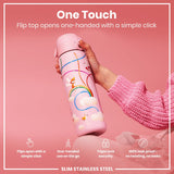 A pink water bottle, featuring a fairy design, is held; its flip top opens with a single click. The bottle is slim and made of stainless steel.