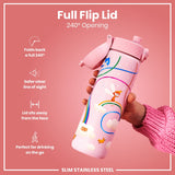 A pink stainless steel water bottle, with a fairy design, is held; its full flip lid opens 240°. The bottle is slim and designed for on-the-go drinking.