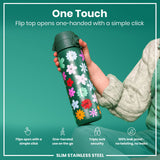 A floral-designed, dark-green, slim stainless steel water bottle is held; its flip top opens with a single click. The context is a teal background.