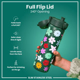 A green, flower-decorated, stainless steel water bottle is held; its full flip lid opens 240 degrees. The bottle is slim and designed for on-the-go use.