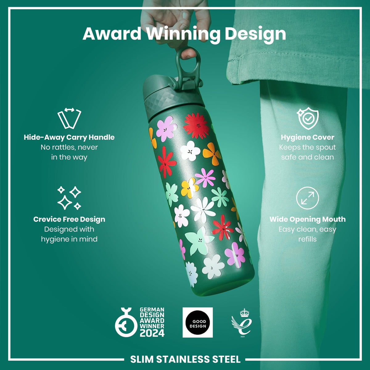 A slim stainless steel water bottle, being held, features a floral design. It has a hide-away handle, crevice-free design, hygiene cover, and wide opening mouth. The bottle is an award-winning design.