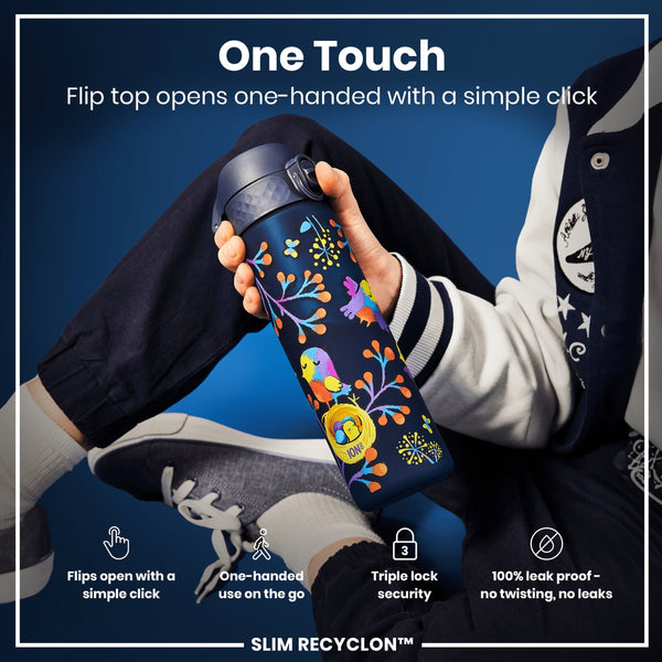 A water bottle with a flip top is being held; the top opens with a single click. The bottle has a colorful bird design; the person is wearing a jacket. “One Touch”, “Flips open with a simple click”, “One-handed use on the go”, “Triple lock security”, “100% leak proof - no twisting, no leaks”, and “SLIM RECYCLON™” are visible.