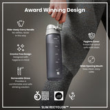 A dark gray water bottle is held; it features a handle, removable straw, and wide mouth. The bottle is advertised as an award-winning design with hygienic features. 