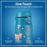 A teal water bottle, featuring a flip top, opens one-handed. The bottle is decorated with a festive design, and includes features such as triple lock security and leak proof capabilities. 