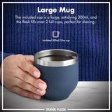 A hand holds a blue insulated mug containing liquid on a marble surface with text reading: 