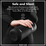 A person holds a black travel flask with a soft base for silent placement. Text: 