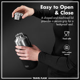 Hands holding and unscrewing a stainless steel flask lid in a dim setting Text reads Easy to Open & Close A shaped and machined lid provides a secure grip for a leakproof seal Food safe BPA FREE 100% carbon neutral TRAVEL FLASK