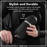 Person holding a black stainless steel flask labeled 