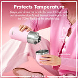 A person pours liquid from a pink insulated travel flask into a matching cup while sitting against a pink background. Text reads: 
