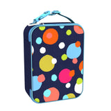 A rectangular lunchbox featuring colorful polka dots is standing upright with a light blue zipper and handle in a bright setting.