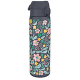 A tall, dark gray water bottle featuring a vibrant floral pattern with pink, yellow, and green flowers stands alone against a white background.