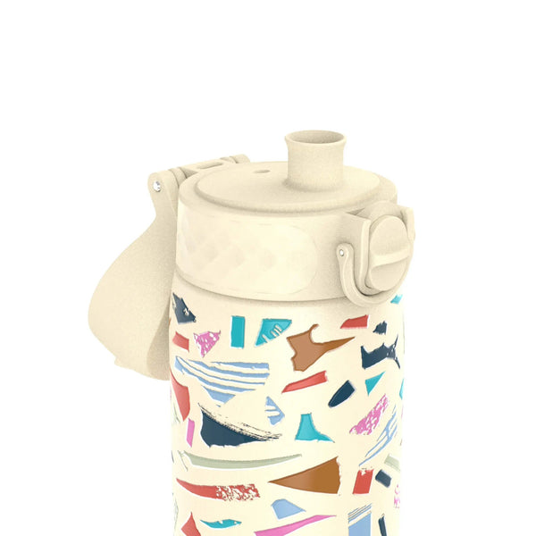 A water bottle with a cream-colored lid and spout displays a colorful abstract pattern featuring various geometric shapes against a plain white background.