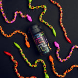 A black water bottle, decorated with colorful, playful snake designs, sits on a dark background surrounded by multicolored toy snakes in vibrant red, orange, pink, and green.